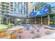 Open city square with tables, chairs, buildings, and large advertisement screens at 1863 Wazee St # 6B, Denver, CO 80202