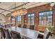 Bright dining room features hardwood floors, exposed brick, and ample natural light through the large windows at 1863 Wazee St # 6B, Denver, CO 80202