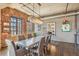 Bright dining room with hardwood floors, exposed brick, and a stunning modern chandelier over the table at 1863 Wazee St # 6B, Denver, CO 80202