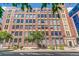 Exterior of brick building with many windows, trees, sidewalk, and street view at 1863 Wazee St # 6B, Denver, CO 80202