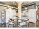 Modern kitchen featuring sleek cabinets, stainless steel appliances, and a round kitchen island with seating at 1863 Wazee St # 6B, Denver, CO 80202