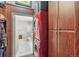 Hidden laundry room with a bright red washer/dryer next to full bathroom at 1863 Wazee St # 6B, Denver, CO 80202