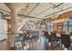 Spacious living area with exposed brick, concrete ceilings, and a large dining table for entertaining at 1863 Wazee St # 6B, Denver, CO 80202