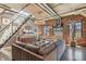 Stylish living room featuring exposed brick, industrial-style ceiling, and modern staircase to the upper level at 1863 Wazee St # 6B, Denver, CO 80202