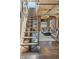 Stylish living room boasts exposed brick, hardwood floors, and a modern staircase at 1863 Wazee St # 6B, Denver, CO 80202