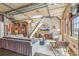 Modern living room featuring exposed brick, concrete ceilings, comfortable seating, and staircase at 1863 Wazee St # 6B, Denver, CO 80202