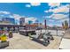 Enjoy this rooftop deck with lounge chairs, BBQ, and a captivating city skyline view at 1863 Wazee St # 6B, Denver, CO 80202