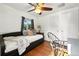 Bright bedroom with hardwood floors, a ceiling fan, and two windows for natural light at 4315 S Elati St, Englewood, CO 80110