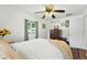 Bright bedroom with a ceiling fan, hardwood floors, and a dresser for storage at 4315 S Elati St, Englewood, CO 80110