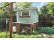 Close-up of the chicken coop, with fenced enclosure for fowl, nestled among the backyard greenery at 4315 S Elati St, Englewood, CO 80110