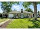 Charming single-story home featuring a well-maintained lawn, carport, and welcoming front porch at 4315 S Elati St, Englewood, CO 80110