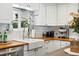 Charming kitchen featuring a farmhouse sink, white cabinets, butcher block counters, and stylish decor at 4315 S Elati St, Englewood, CO 80110