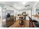 Updated kitchen with white cabinets, butcher block counters, stainless appliances, and mobile island cart at 4315 S Elati St, Englewood, CO 80110