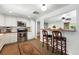 Bright, efficient kitchen featuring white cabinetry, stainless steel appliances, and an adjacent breakfast bar at 4315 S Elati St, Englewood, CO 80110