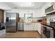 Bright, efficient kitchen featuring white cabinetry, stainless steel appliances, and butcher block countertops at 4315 S Elati St, Englewood, CO 80110