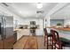 Modern kitchen featuring stainless steel appliances, white cabinets, and an adjacent breakfast bar with stools at 4315 S Elati St, Englewood, CO 80110