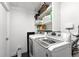 Practical laundry room with washer, dryer, and shelving for organization and convenience at 4315 S Elati St, Englewood, CO 80110