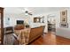 Inviting living room with hardwood floors, stylish decor, and an open view into the kitchen at 4315 S Elati St, Englewood, CO 80110