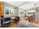 Cozy living room with large windows, hardwood floors, and vintage furnishings at 4315 S Elati St, Englewood, CO 80110