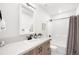 Updated bathroom featuring a vanity, framed mirror, updated fixtures, and a shower-tub combo at 1103 Spartan Ave, Berthoud, CO 80513