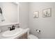 Neutral powder bath with a modern sink, faucet, framed mirror, and decorative wall art at 1103 Spartan Ave, Berthoud, CO 80513