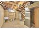 Unfinished basement with exposed utilities, laundry sink and window at 641 E 104Th Pl, Northglenn, CO 80233
