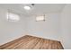 Clean basement featuring hardwood floors, light-colored walls, and a ceiling light, creating a livable space at 641 E 104Th Pl, Northglenn, CO 80233