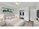 Cozy bedroom showcasing a tufted headboard bed, closet, and a window with natural light at 641 E 104Th Pl, Northglenn, CO 80233