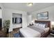 Comfortable bedroom featuring an inviting bed with stylish pillows, a closet, and a side table at 641 E 104Th Pl, Northglenn, CO 80233