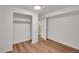 Clean bedroom featuring hardwood floors, light-colored walls, and a closet, creating a modern atmosphere at 641 E 104Th Pl, Northglenn, CO 80233