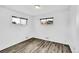 Clean bedroom featuring hardwood floors, light-colored walls, and two windows, creating a relaxing atmosphere at 641 E 104Th Pl, Northglenn, CO 80233