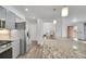 Modern kitchen featuring a large island with a granite countertop and stainless steel appliances at 641 E 104Th Pl, Northglenn, CO 80233