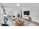 Bright, open-concept living room features a modern design with a dining area and kitchen in the background at 641 E 104Th Pl, Northglenn, CO 80233