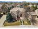 Beautiful brick home featuring professional landscaping and a large front yard, with scenic mountain views in the background at 7425 S Utica St, Littleton, CO 80128