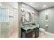 Modern bathroom with glass vessel sink, glass shower and natural light at 7425 S Utica St, Littleton, CO 80128