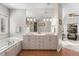 Bright bathroom featuring double sinks, bathtub, and a separate shower room at 7425 S Utica St, Littleton, CO 80128