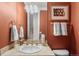 Cozy bathroom with a marble countertop, a decorative mirror and gold colored fixtures at 7425 S Utica St, Littleton, CO 80128