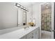 Bathroom with a single sink, white tile countertop, and a shower/tub combination at 7425 S Utica St, Littleton, CO 80128
