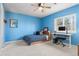 Bedroom painted in bright blue featuring a desk, chair, and a ceiling fan at 7425 S Utica St, Littleton, CO 80128