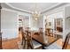Bright dining room featuring hardwood floors and an elegant chandelier, perfect for Gathering meals and entertaining at 7425 S Utica St, Littleton, CO 80128