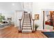 Welcoming entryway with hardwood floors and staircase, creating an inviting first impression at 7425 S Utica St, Littleton, CO 80128