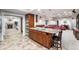 Bright kitchen with island and seating open to a large living area at 7425 S Utica St, Littleton, CO 80128