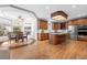 Well-appointed kitchen features wooden cabinets, stainless steel appliances, an island and a charming breakfast nook at 7425 S Utica St, Littleton, CO 80128