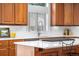 Close up shot of a well-equipped kitchen island features a gas cooktop and stunning white countertops at 7425 S Utica St, Littleton, CO 80128