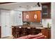 Well-lit kitchen features a breakfast bar, custom lighting and lovely cabinets at 7425 S Utica St, Littleton, CO 80128