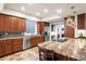 Spacious kitchen with stainless steel appliances and a granite-topped island at 7425 S Utica St, Littleton, CO 80128