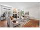 Bright living room featuring a fireplace, hardwood floors, neutral tones, and comfortable seating arrangements at 7425 S Utica St, Littleton, CO 80128