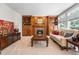 Inviting living room boasts a cozy fireplace with built-in shelving and large windows for plenty of natural light at 7425 S Utica St, Littleton, CO 80128