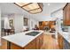 Open layout showcasing the kitchen island flowing into the living room with built-in bookcases and a fireplace at 7425 S Utica St, Littleton, CO 80128