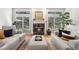 Comfortable living room featuring a fireplace, hardwood floors, neutral tones, and comfortable seating arrangements at 7425 S Utica St, Littleton, CO 80128